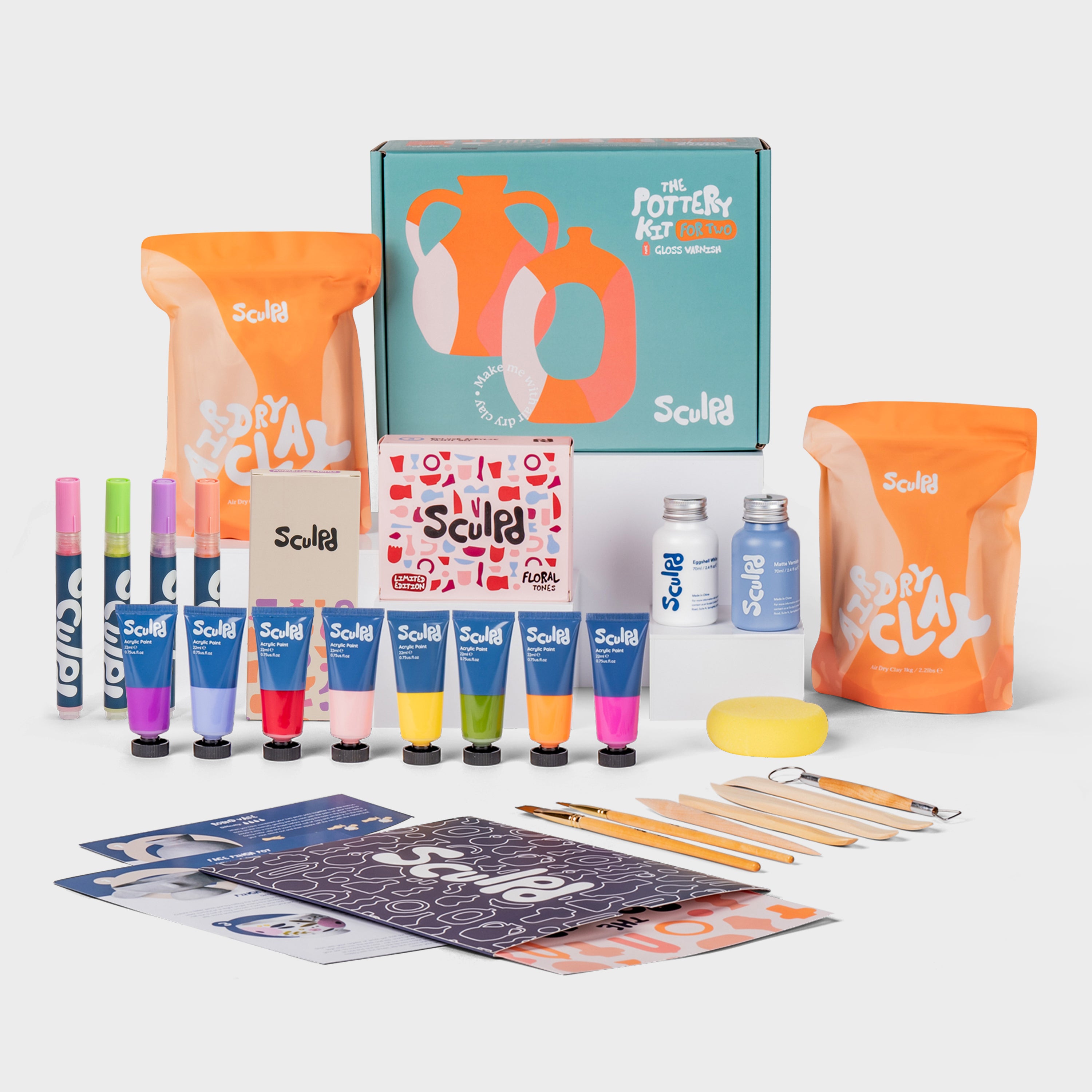 Sculpd pottery kit for two in a green box with floral paints, and Modernist pens set