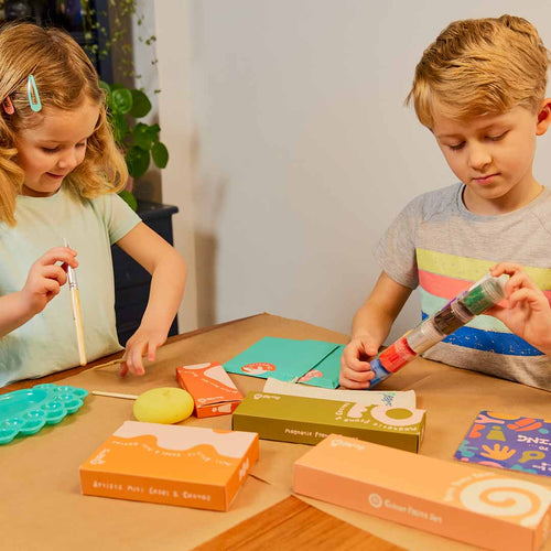 Two children playing with Sculpd Kids Canvas Painting Kit on a table