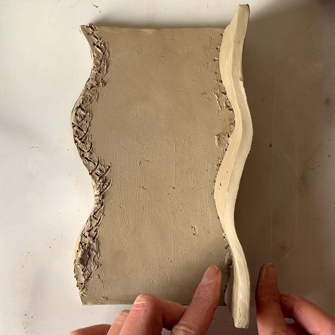 A slab of clay being hand-shaped and made using Sculpd Pottery Kit